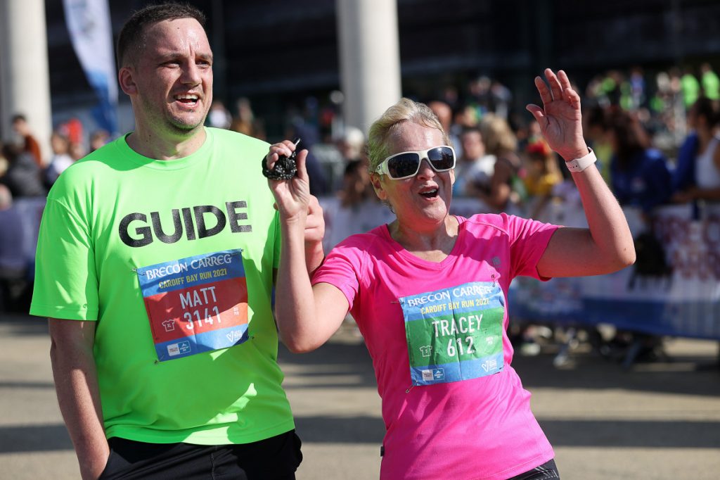 An image of a blind athlete with a guide runner at the Cardiff Bay 10K